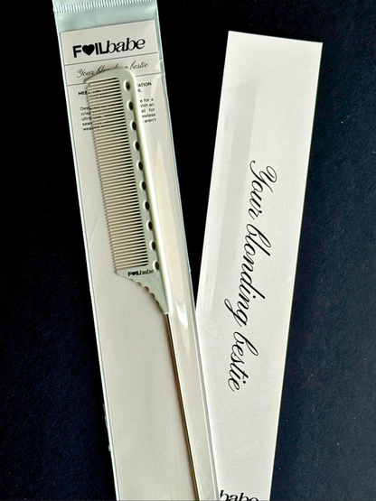 Hair blonding comb with packaging on a dark background