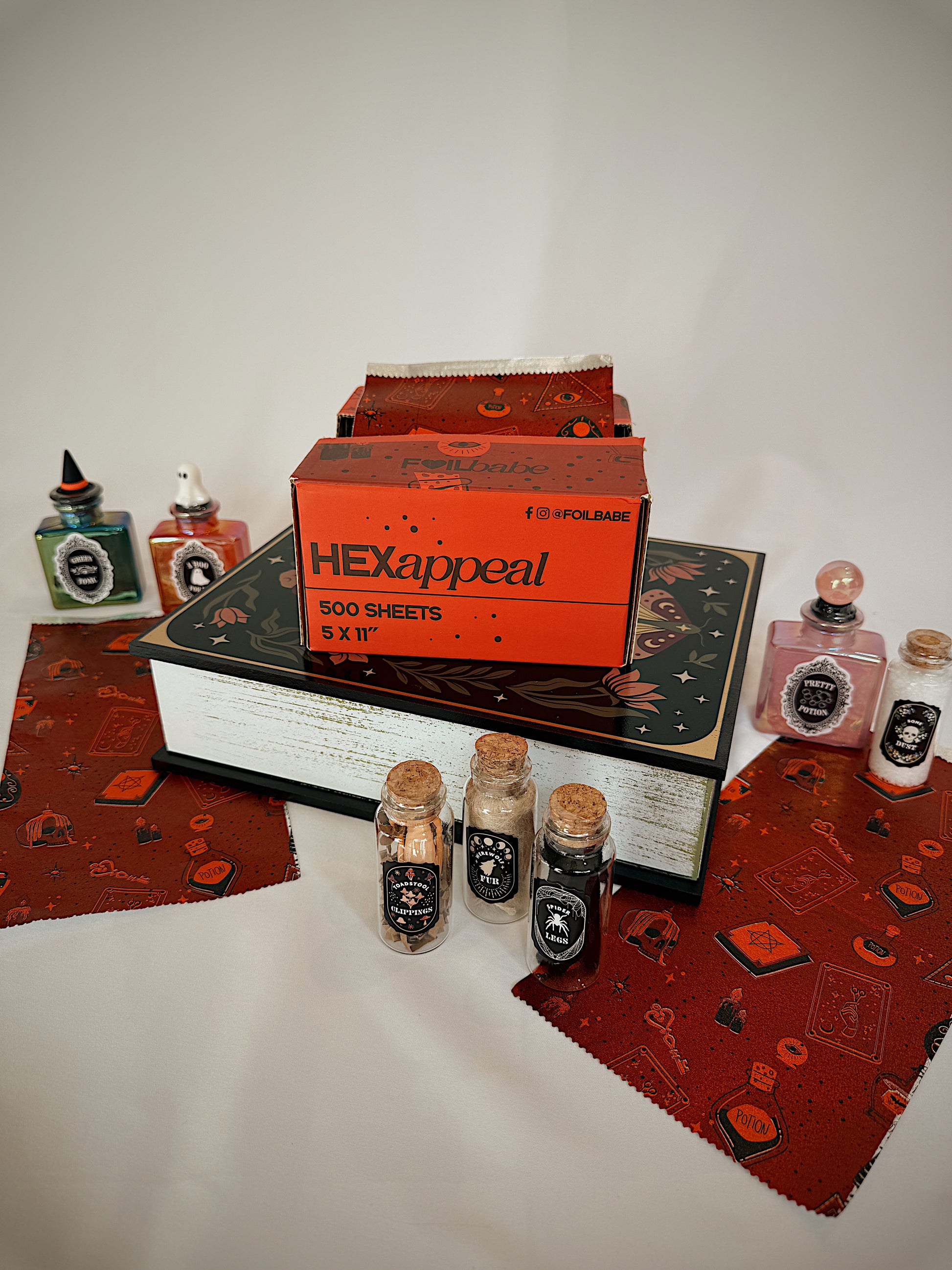 Collection of stationery items including a box labeled 'HEXappeal' on a textured surface.