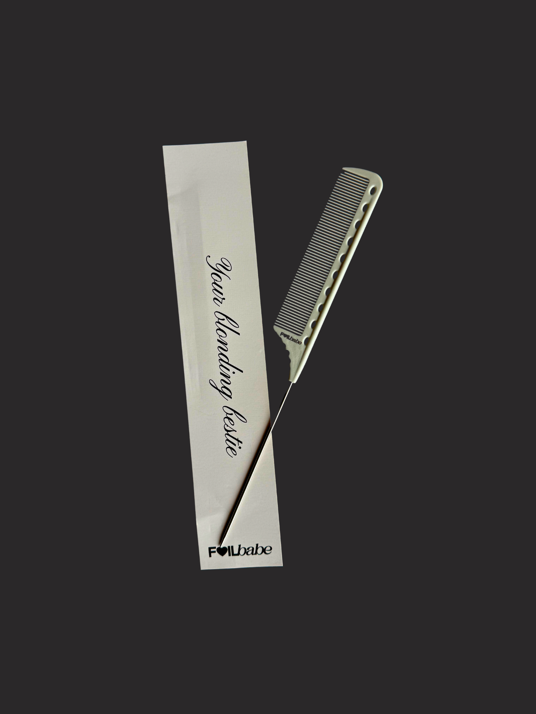 Hair comb and styling tool with a branded card on a black background